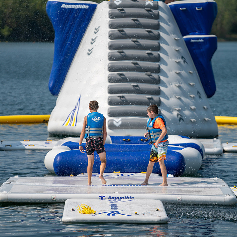 Two kids in life jackets enjoy the Landing Pad course.